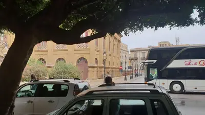 a group of cars parked on a street with a bus at Le Stelle del Massimo in Palermo