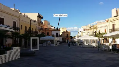 a person walking down a street in a city at Casa Madonia in Terrasini