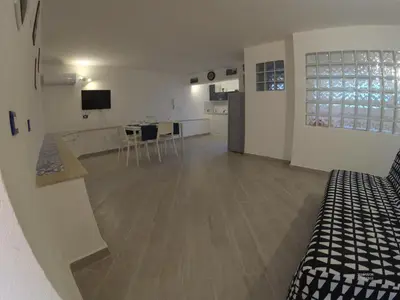 a large room with a kitchen and a living room at la petit maison in Palermo
