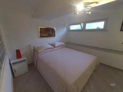 a small bedroom with a bed and a window at la petit maison in Palermo