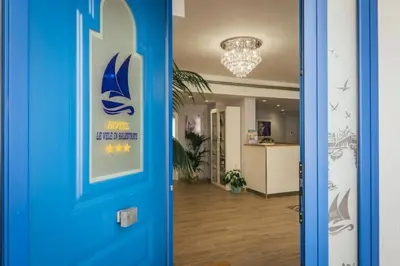 a blue door with a sign on it in a room at Le Vele di Balestrate in Balestrate