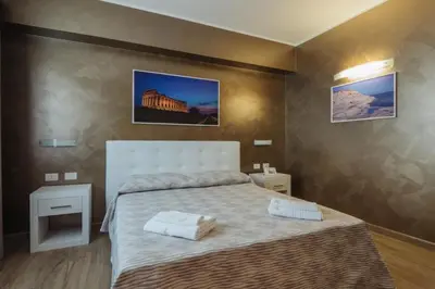 a bedroom with a bed with two towels on it at Le Vele di Balestrate in Balestrate