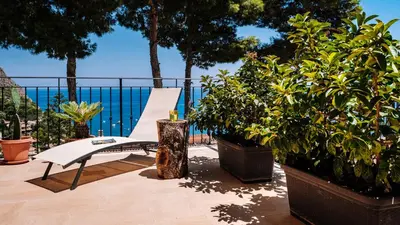 a white bench sitting on a patio with plants at Villa Zabbara Capo Zafferano in Bagheria