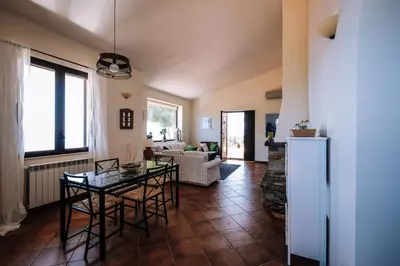 a living room with a table and chairs at Villa Zabbara Capo Zafferano in Bagheria