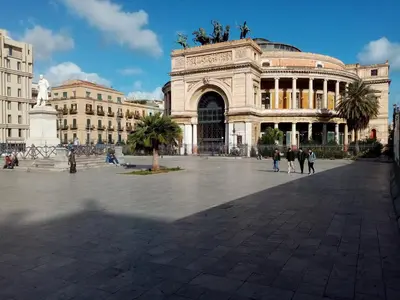 a large building with people walking in front of it at Ariston Petit Hotel in Palermo