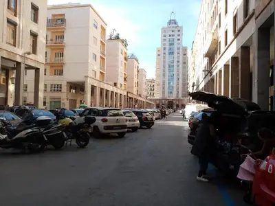a city street with cars parked on the side of the road at Ariston Petit Hotel in Palermo