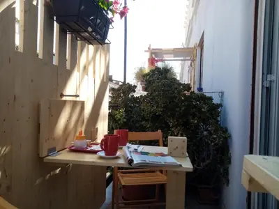 a small table in the side of a building with a table and chairs at Ariston Petit Hotel in Palermo