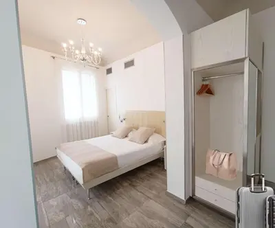 a white bedroom with a bed and a mirror at Best Western Hotel Principe di Lampedusa in Palermo
