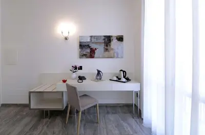 a white desk with a chair next to a table at Best Western Hotel Principe di Lampedusa in Palermo