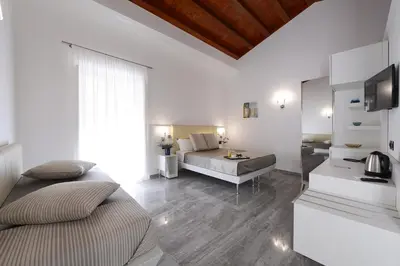 a bedroom with a bed and a couch in a room at Best Western Hotel Principe di Lampedusa in Palermo