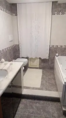 a bathroom with a shower and a washing machine at A casa di Elena in Alcamo