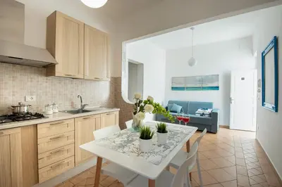 a kitchen and living room with a table and chairs at Casa vacanze Mare Nostrum in Castellammare del Golfo