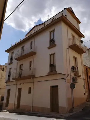 a large white building with balconies on a street at I Paesaggi in Castellammare del Golfo