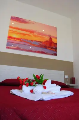 a bed with towels and flowers on top of it at I Paesaggi in Castellammare del Golfo