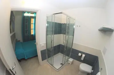 a bathroom with a glass shower with a toilet at I Paesaggi in Castellammare del Golfo