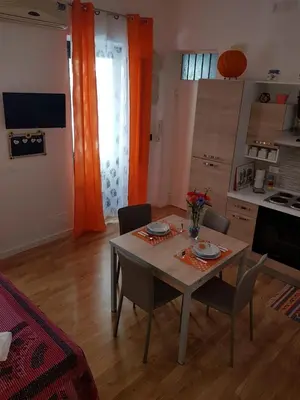 a kitchen with a table and chairs in a room at La Casetta in Palermo