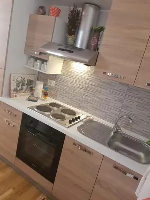 a kitchen with a stove and a sink at La Casetta in Palermo