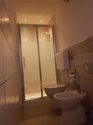a bathroom with a toilet and a sink and a shower at La Casetta in Palermo