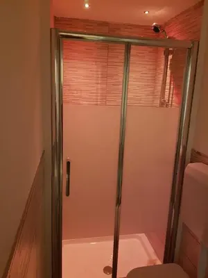 a shower with a glass door in a bathroom at La Casetta in Palermo