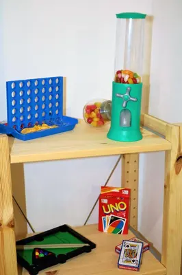 a wooden shelf with a table with a bin of fruit at Palermo Home White Home in Palermo