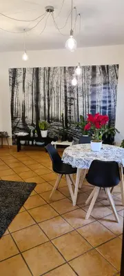 a dining room with a table and chairs and a mural at Virginia House in Palermo