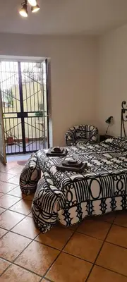 two beds sitting in a room with a room with a window at Virginia House in Palermo