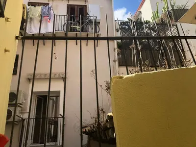 a white building with a balcony with a bike on it at Virginia House in Palermo