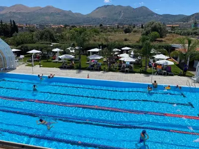 a group of people swimming in a swimming pool at Piano Monaco in Carini