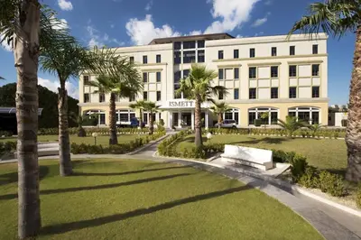 a large white building with palm trees in front of it at Al Civico 8 - Palermo in Palermo