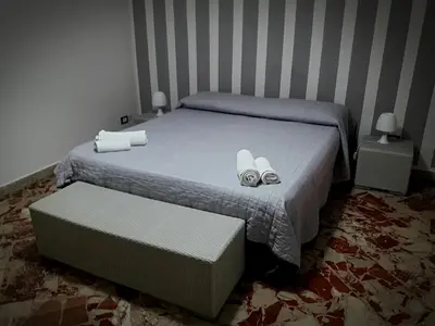 a bedroom with a bed with two pairs of shoes on it at Al Civico 8 - Palermo in Palermo