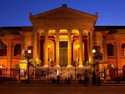 a large building with people standing in front of it at Al Civico 8 - Palermo in Palermo