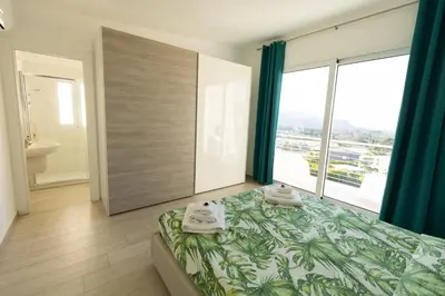 a bedroom with a bed with towels on it at Villa Cristina - Relax - Piscina e Vista Mare in Castellammare del Golfo