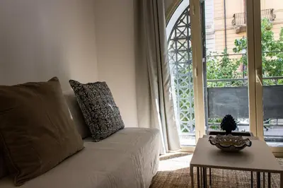 a living room with a couch and a table and a window at Central Mezzanine in Palermo