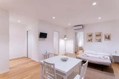a white living room with a table and a couch at Central Mezzanine in Palermo