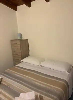 a small bedroom with a bed and a dresser at Villa dei Limoni sul Mare in Castellammare del Golfo