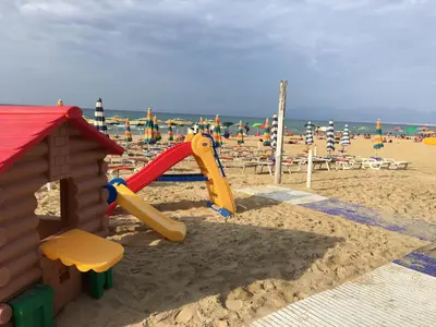 a playground in the sand at the beach at Villa dei Limoni sul Mare in Castellammare del Golfo