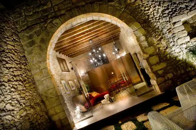 a view of a living room with a stone wall at Borgo degli Angeli Wellness & Resort by Le Dhome Sicily in Balestrate