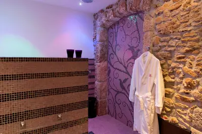 a room with a stone wall and a door at Borgo degli Angeli Wellness & Resort by Le Dhome Sicily in Balestrate