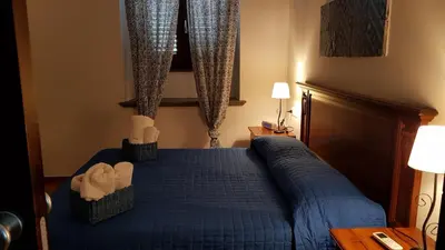 a bedroom with a blue bed with two baskets at Casa Vacanze Villa D'Orleans in Palermo