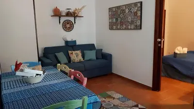 a living room with a blue couch and a table at Casa Vacanze Villa D'Orleans in Palermo