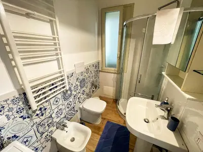 a bathroom with a toilet and a sink and a shower at Baglio Reale Apartments in Palermo