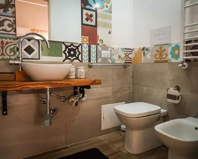 a bathroom with a sink and a toilet at Baglio Reale Apartments in Palermo
