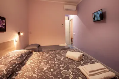 a hotel room with a bed and a couch at Affittacamere da Noemi in Castellammare del Golfo