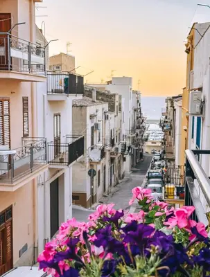 a view of a street with flowers on a balcony at Affittacamere da Noemi in Castellammare del Golfo