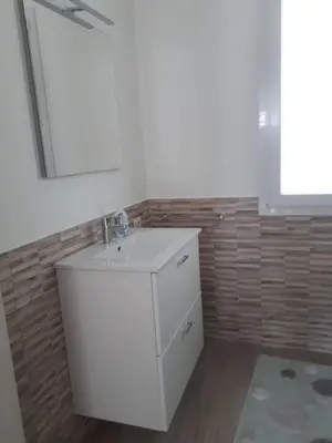 a bathroom with a white sink and a mirror at Villa Verde in Alcamo