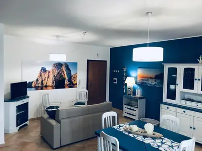 a living room with a couch and a table at Appartamento BluOltreMare in San Vito lo Capo