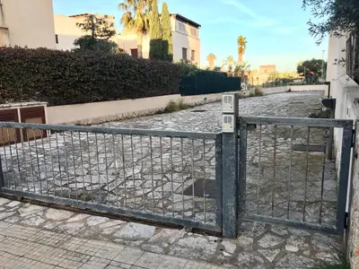 an iron gate on a street at Appartamento BluOltreMare in San Vito lo Capo