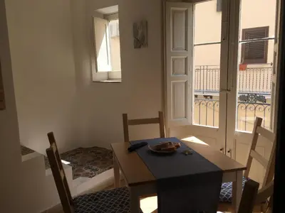 a dining room with a table and chairs and a window at Casa Vacanze Mannina in Castellammare del Golfo