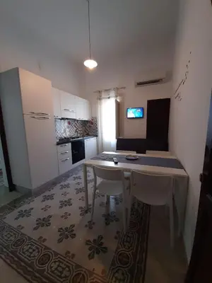 a small kitchen with a table in a room at Casa Vacanze Mannina in Castellammare del Golfo