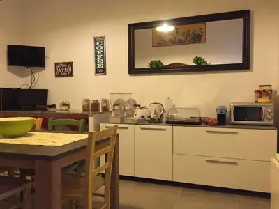 a kitchen with a table and a microwave at YooRoom in Palermo